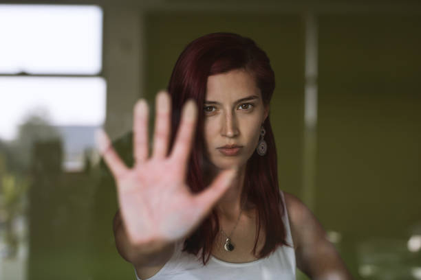 istock Young attractive woman watching out the window with reflections 1164521323