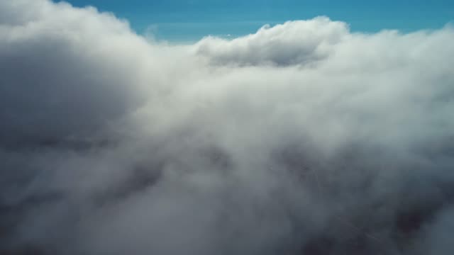 Atmospheric smoke 4K Fog effect. VFX Element. Abstract smoke cloud. Smoke in slow motion on blue sky. White smoke slowly floating through space against blue sky.
