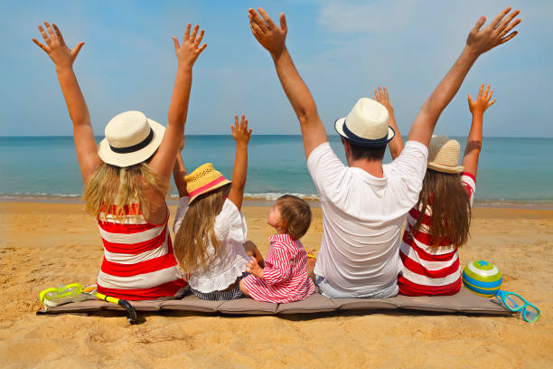 istock Family of five on the beach 1164524102