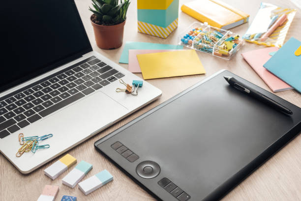 istock drawing tablet, stationery and laptop on wooden table 1164524197