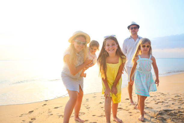 istock Happy young family have fun on beach 1164525084
