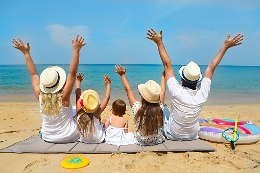 Family of five on the beach. Travel and family vacation concept