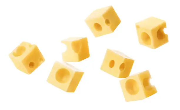 Falling cubic pieces of delicious cheese, isolated on white background