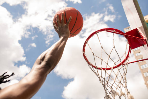 istock African basketball player throwing ball into basket during game or training 1164525246