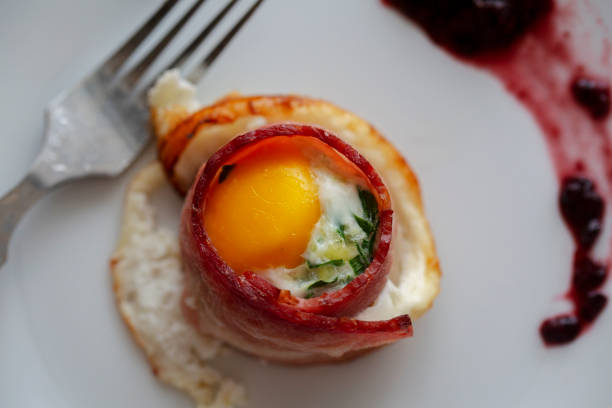 Breakfast with bacon , fried egg, coffee and vegetables