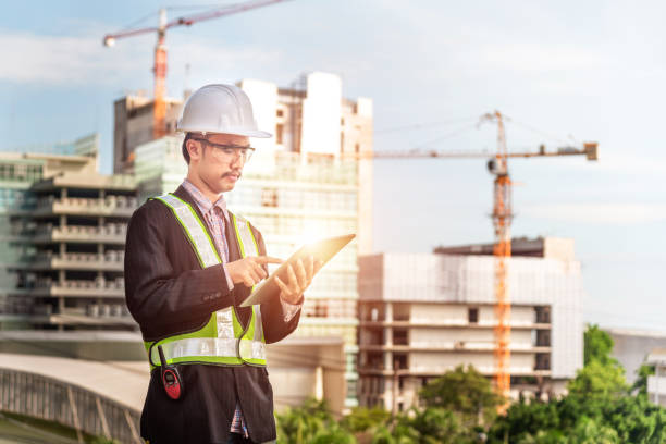 istock Close up engineers working on a building site holding a blueprints.Engineering and architecture concept 1164526538