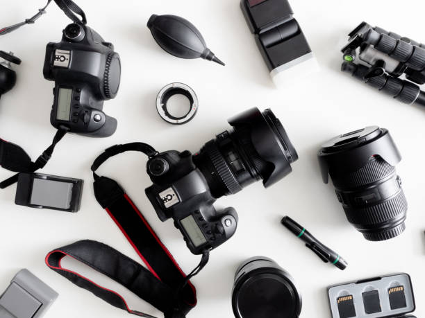 istock top view of work space photographer with digital camera, flash, cleaning kit, memory card, tripod and camera accessory on white table background 1164527990