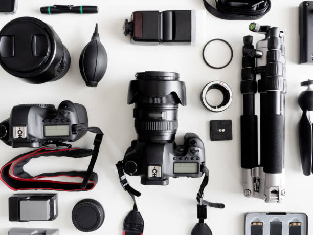 istock top view of work space photographer with digital camera, flash, cleaning kit, memory card, tripod and camera accessory on white table background 1164528021