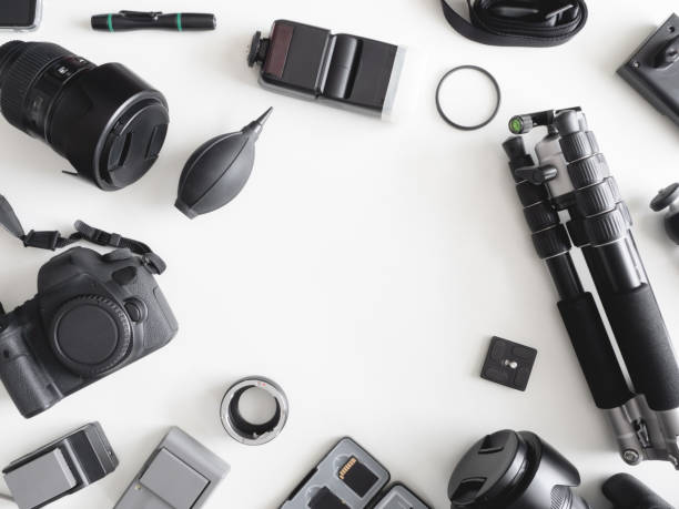 istock top view of work space photographer with digital camera, flash, cleaning kit, memory card, tripod and camera accessory on white table background 1164528022