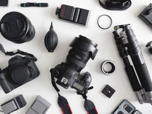 istock top view of work space photographer with digital camera, flash, cleaning kit, memory card, tripod and camera accessory on white table background 1164528023