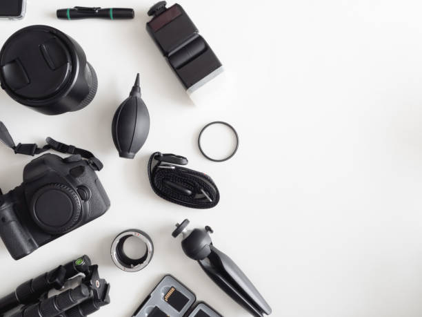istock top view of work space photographer with digital camera, flash, cleaning kit, memory card, tripod and camera accessory on white table background 1164528043