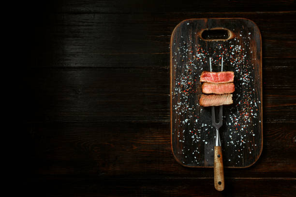 istock Three pieces of meat on a fork for meat 1164528805