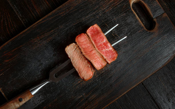 istock Three pieces of meat on a fork for meat 1164528807