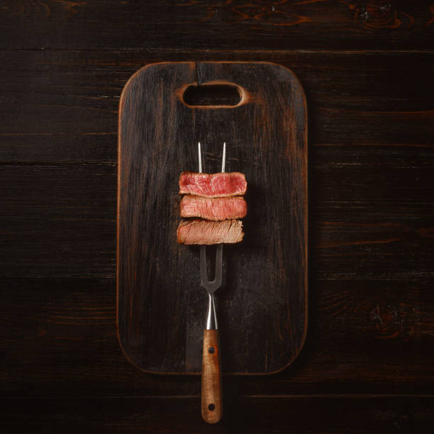 Three pieces of meat on a fork for meat