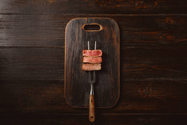 istock Three pieces of meat on a fork for meat 1164528810