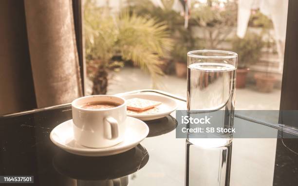 White Coffee Cup Placed On The Dining Table While Morning Sunlight Coming From The Window Stock Photo - Download Image Now