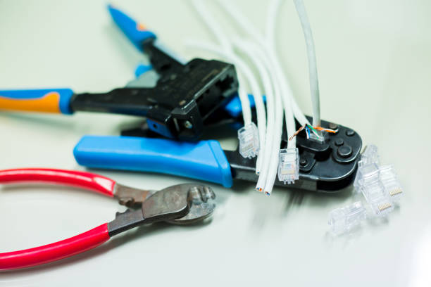 istock Crimper and wire cutter isolated on a white background. Twisting Cable Tool Twisted Pair Ethernet UTP Cat 5, Crimping RJ45 LAN cable, 1164538775