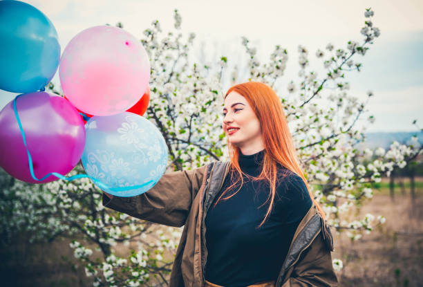 istock Happy woman with balloons 1164538921