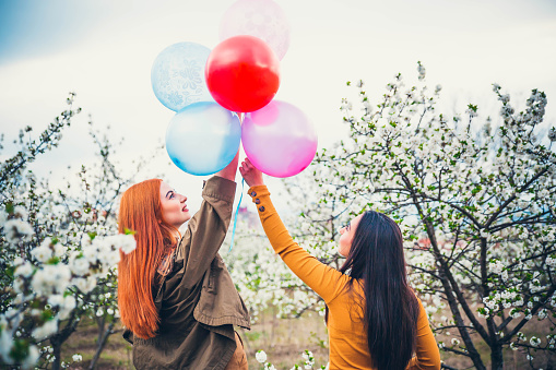 Happy girls holding balloons
