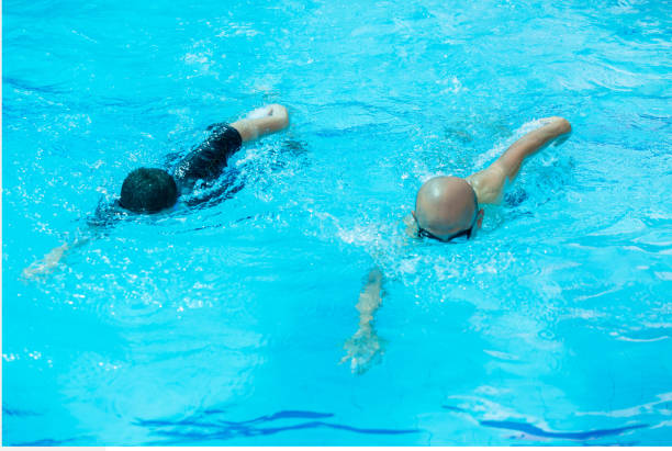 istock The coach is swimming with a child swimmer. 1164540815