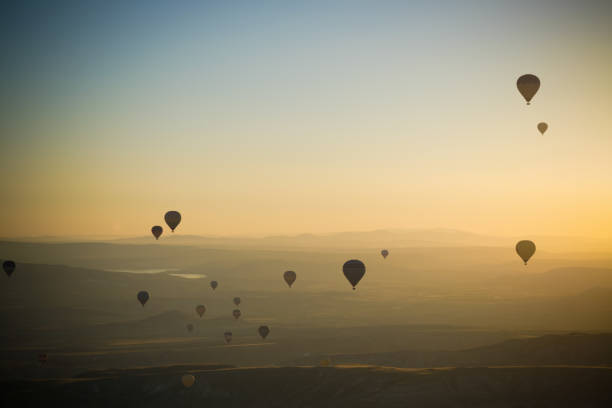 Early morning hot air balloon flight over the rugged landscape around Goreme in Cappadocia Turkey.