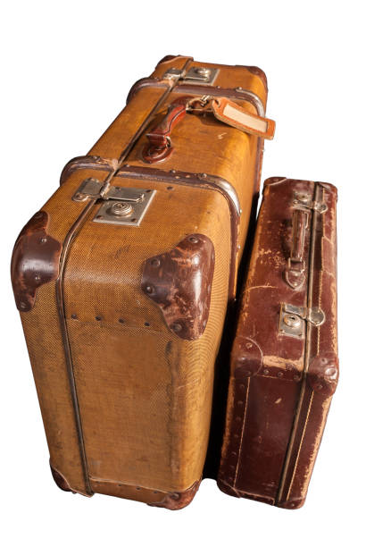 istock two old-fashioned scratched brown suitcases - white, isolated 1164542250