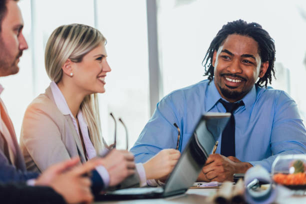 istock Group of young business people working together in creative office. 1164543589