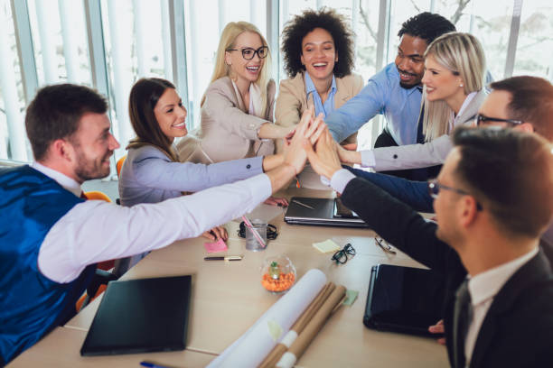 istock Large business team showing unity with their hands together. Selective focus 1164543760