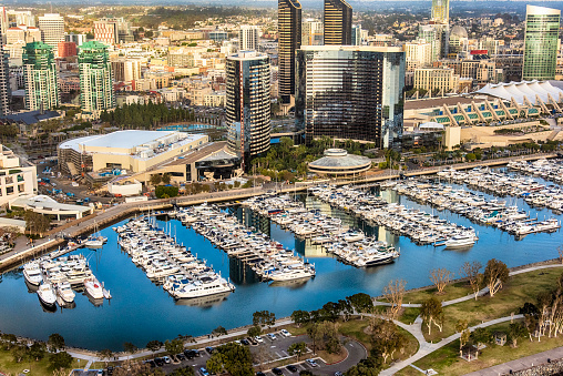 Aerial view of a large marina on San Diego Bay with the buildings of downtown San Diego, California beyond.