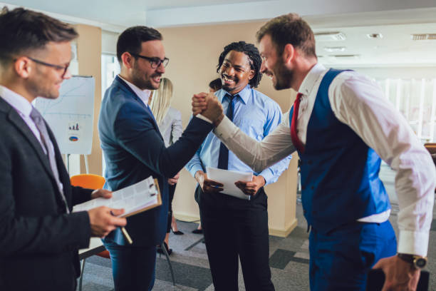 istock Happy businessmen handshaking after negotiation in office. Selective focus. 1164545026