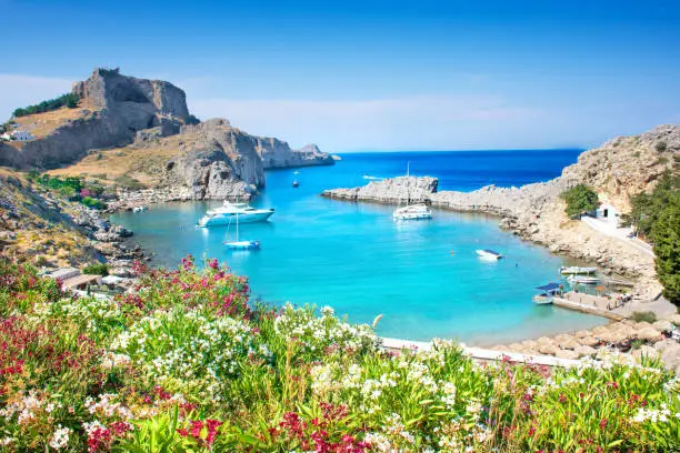 Photo of Lindos â panoramic view of St. Paul bay with acropolis of Lindos in background (Rhodes, Greece)