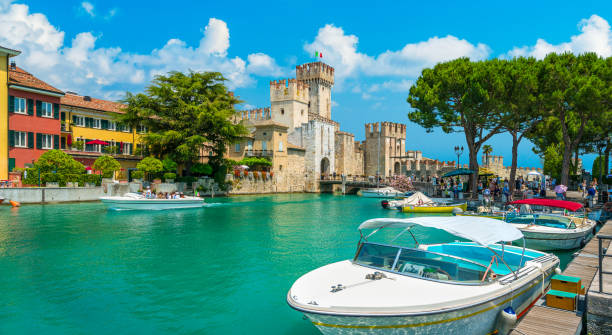 The picturesque town of Sirmione on Lake Garda. Province of Brescia, Lombardia, Italy. The picturesque town of Sirmione with the Scaligero Castle on Lake Garda. Province of Brescia, Lombardia, Italy. italian lake district photos stock pictures, royalty-free photos & images