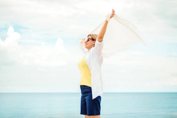 istock Happy mature woman enjoying the wind 1164547888