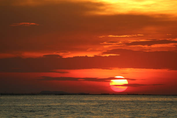 istock sunset on red orange sky back soft evening cloud over horizon sea 1164548882