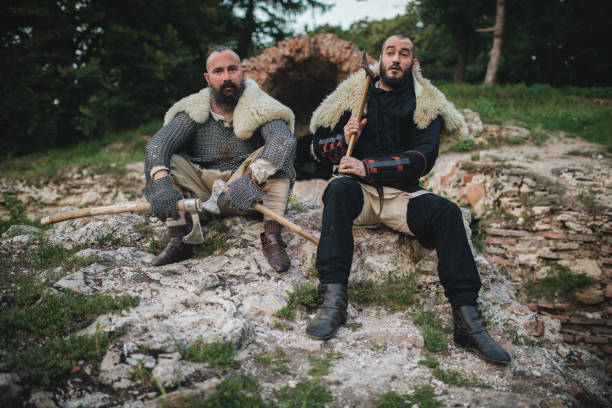 istock Knights with axes sitting outdoors 1164549162