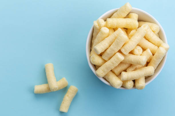 istock Crunchy corn puffs, pufuleti in white bowl - top view 1164550907