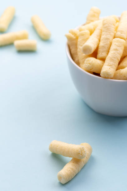 Crunchy corn puffs, pufuleti in white bowl