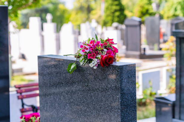 istock Bouquet Flowers on the Gravestone 1164552052