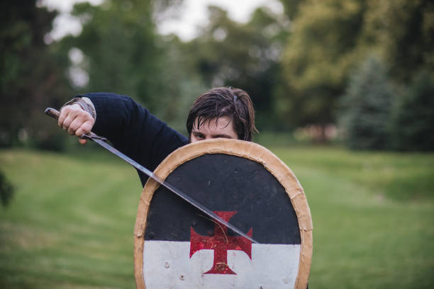 istock Knight hiding behind his shield in a defensive stance 1164552142