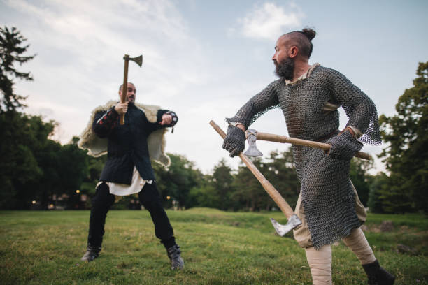 istock Medieval knights swinging axes in a fight 1164553736
