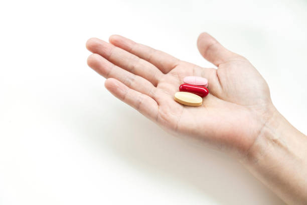 istock Vitamins supplements on woman hand, 1164553746