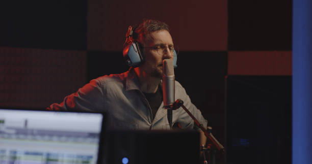 Actor doing voice over in sound studio stock photo