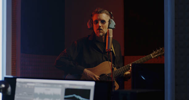 istock Guitarist and sound engineer working in studio 1164554897