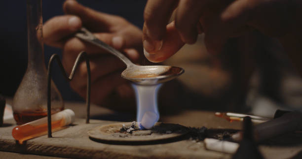 istock Man heating drug in a spoon 1164554917