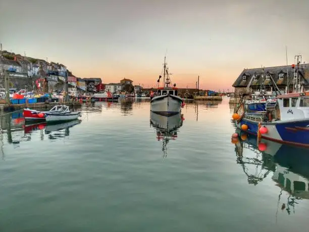 Fishing boats at sunset in Mevagissey harbour, Cornwall in Spring