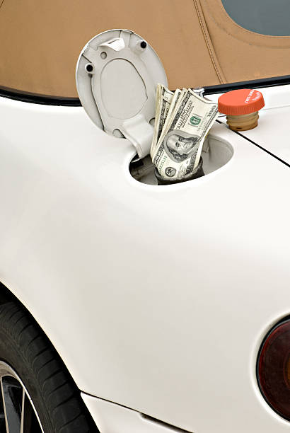istock Car with Hundred Dollar Bills Sucked into Gas Tank 116455570