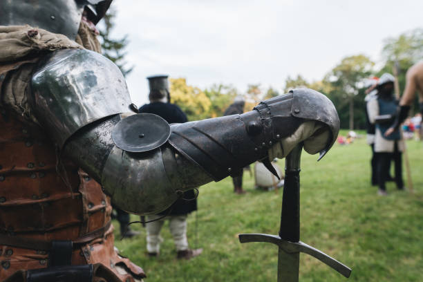 a knight in body armor with a long sword standing at a medieval festival - history knight historical reenactment military imagens e fotografias de stock