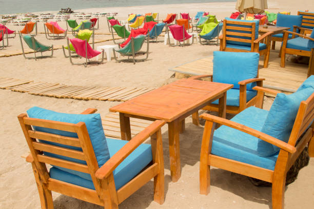 istock Armchairs with soft pillows on the sandy shore. Rest zone 1164556000