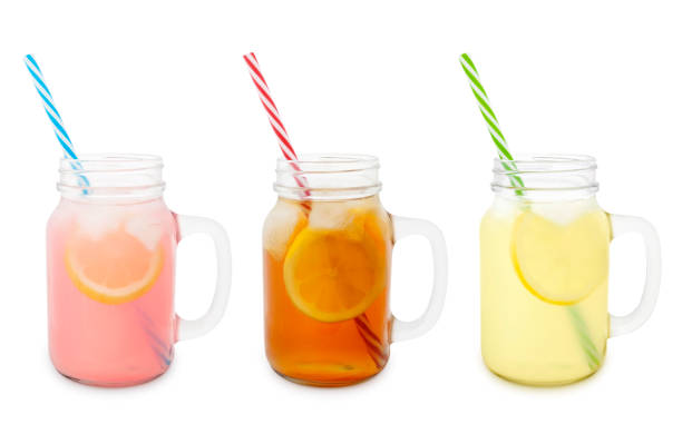 Lemonades and Iced Tea Collection Pink and yellow lemonades and iced tea in jars isolated on white mason jar lemonade stock pictures, royalty-free photos & images