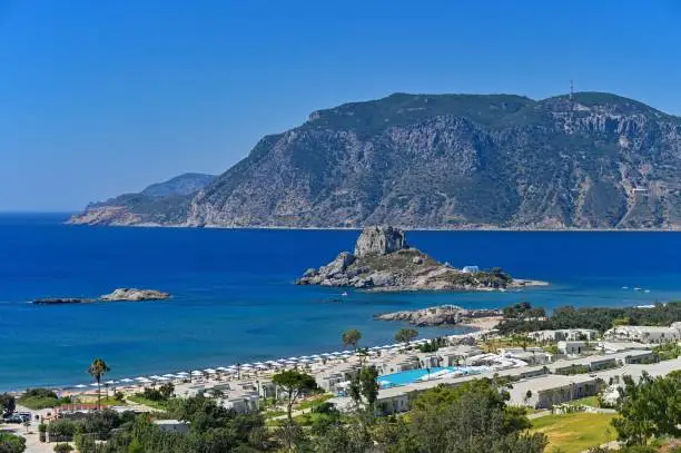 Beautiful beach with sea in tourist resort. Greece island Kos-Agios Stefanos. Beautiful concept for summer vacation. Natural colorful background.